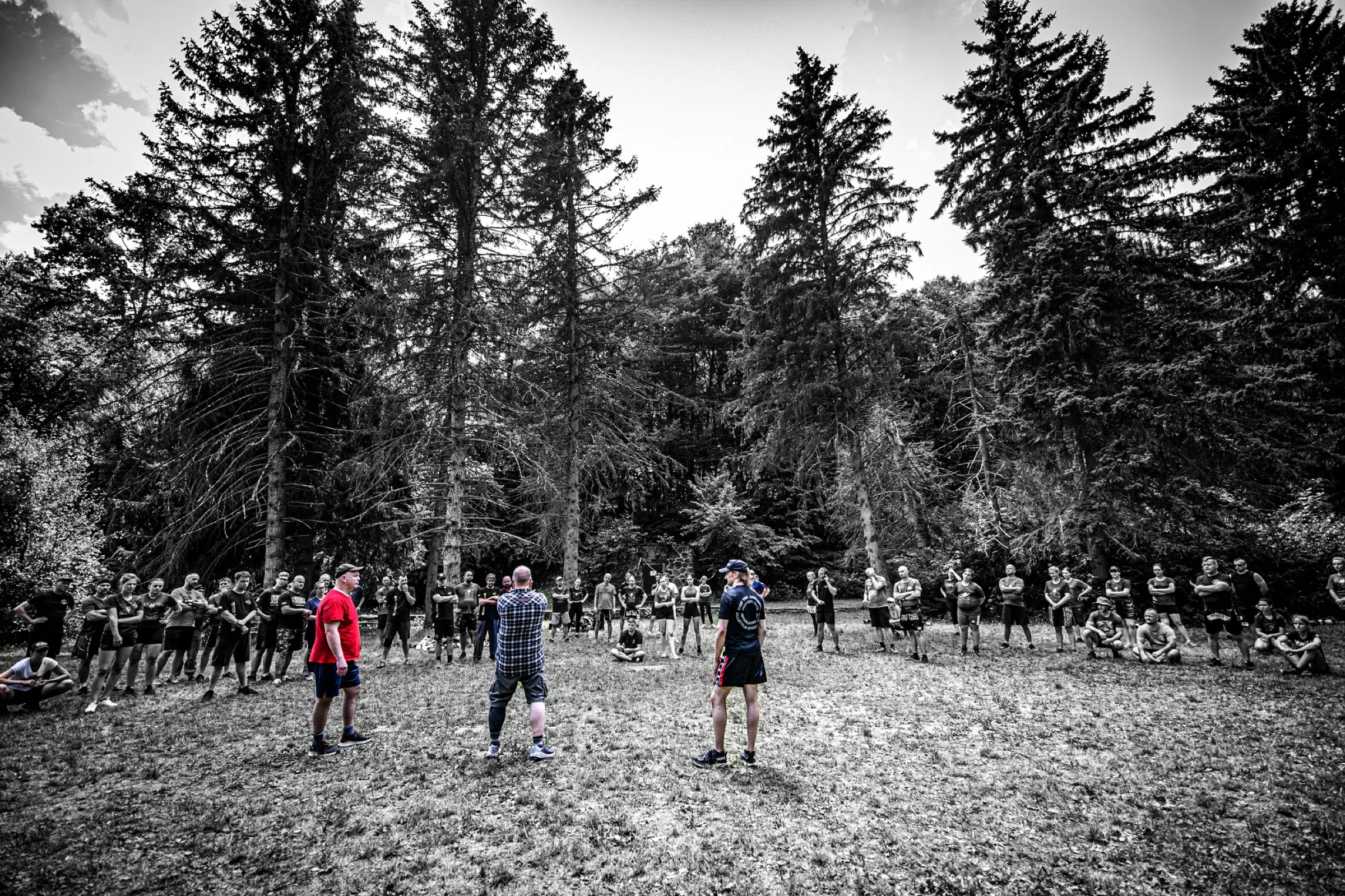 A large Saario seminar group gathered in a forest clearing